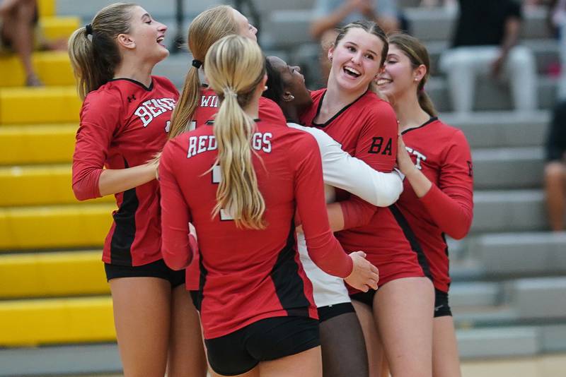 Benet’s Ellie Stiernagle (right) is greeted by her team mates after hitting a match winning ace on a serve during a volleyball match against Metea Valley at Metea Valley High School in Aurora on Wednesday, Sep 4, 2024.