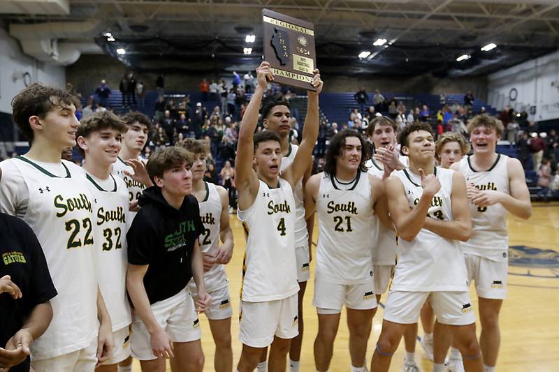 Crystal Lake South's AJ Demirov raises the trophy as he and his teammates celebrate wining the IHSA Class 3A Cary-Grove Boys Basketball Regional Championship game against Wheaton Academy on Friday, Feb. 23, 2024 at Cary-Grove High School.