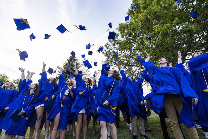 Newman Central Catholic High School grads fire their hats into the air after commencement Wednesday, May 15, 2024.