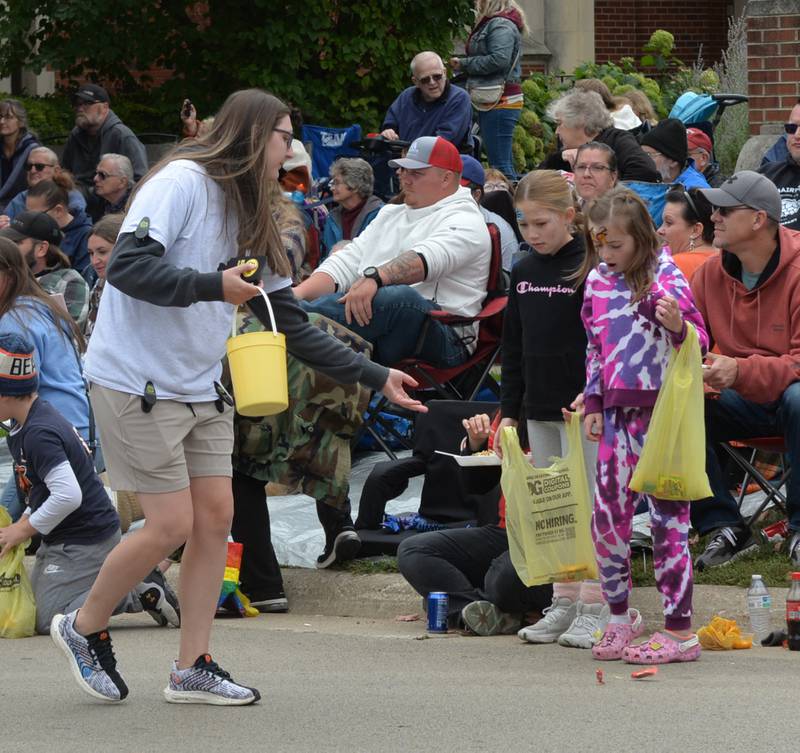 E.D. Etnyre employee Erika Grace of Oregon, gives candy to kids during the Harvest Time Parade, held during Oregon's Autumn on Parade festival on Sunday, Oct. 8, 2023. Etnyre was this year's Unit of Honor.