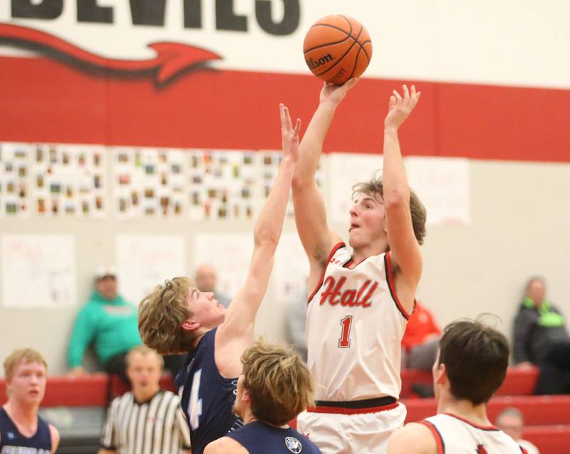 Hall's Joseph Bacidore takes a shot over Bureau Valley's Justin Moon on Tuesday, Feb. 6, 2024 at Hall High School.