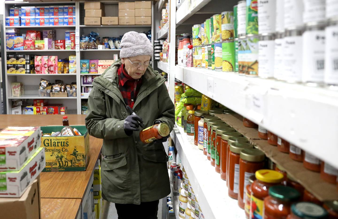 Volunteer Mary Walt of Big Rock stocks the shelves at the Between Friends Food Pantry of Sugar Grove.