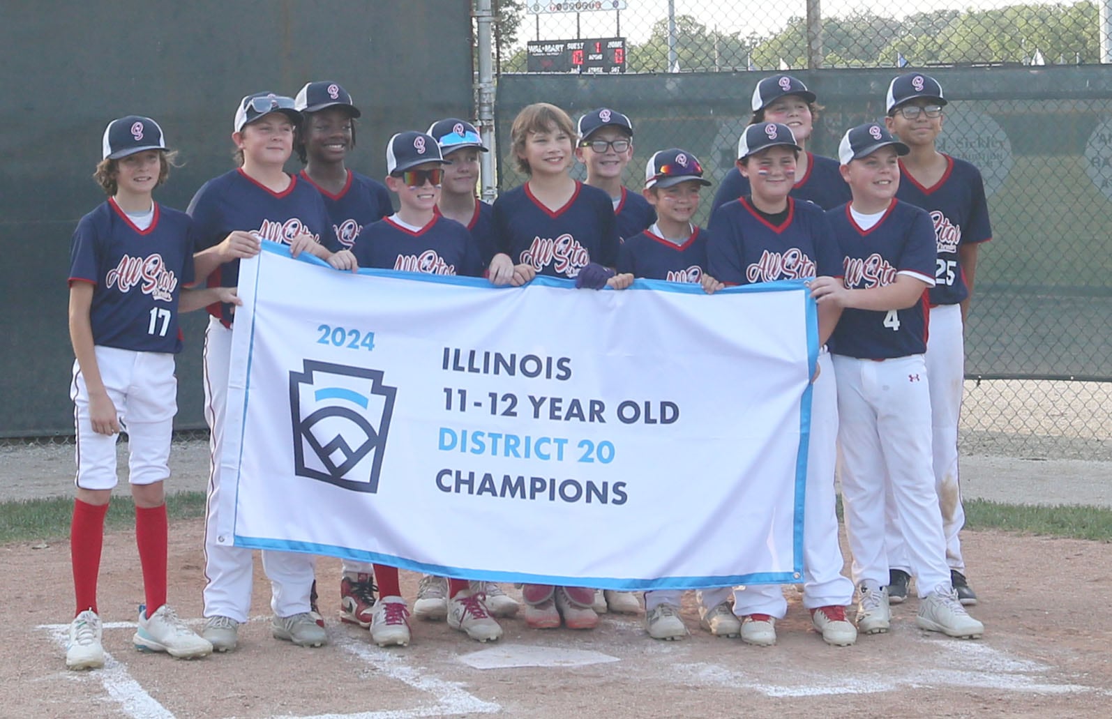 Members of the Streator 12-Year-Old All-Stars pose with their District 20 championship banner after defeating Ottawa American 5-0 on Sunday, July 14, 2024, at Washington Park in Peru.