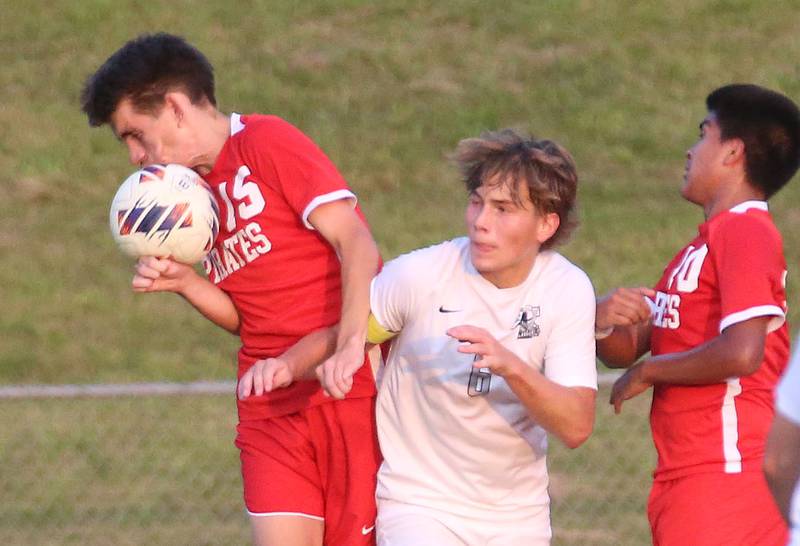 Ottawa's Jordan Arroyo puts a header on the ball while teammate Michael Bedolla watches as Kaneland's Noah McKittrick defends on Wednesday, Sept. 11, 2024 at King Field.