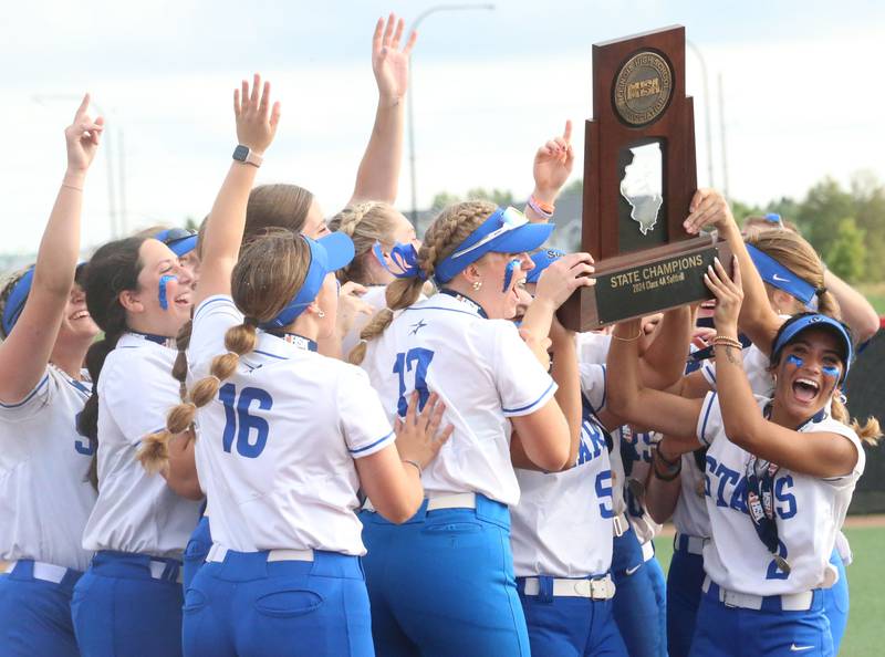 Members of the St. Charles North softball team hoist the Class 4A championship trophy after defeating Marist on Saturday, June 8, 2024 at the Louisville Slugger Sports Complex in Peoria.