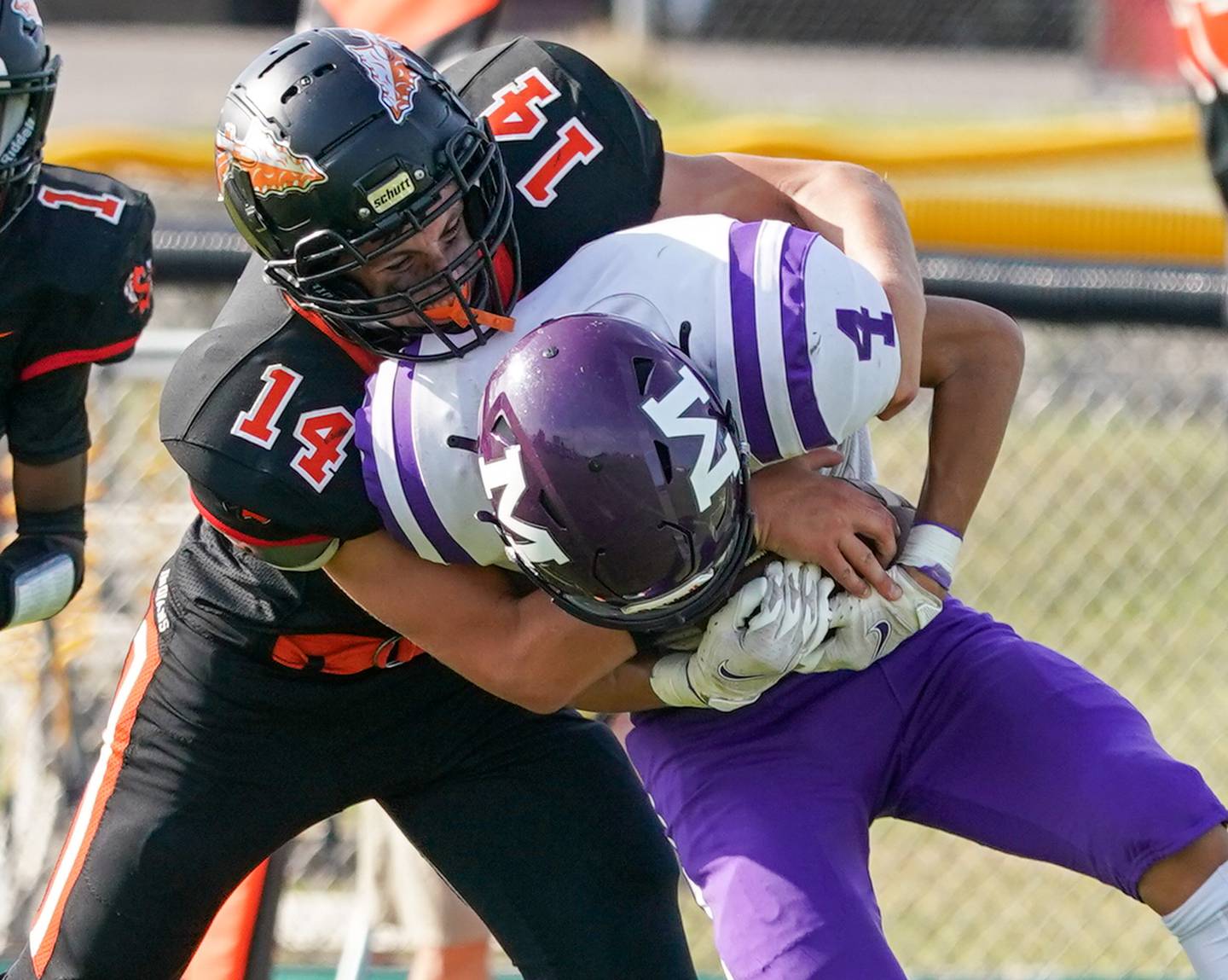 Sandwich Caleb Jones (14) tackles Manteno's Kyle McCullough (4) after the catch during a football game at Sandwich High School on Saturday, Aug 26, 2023.