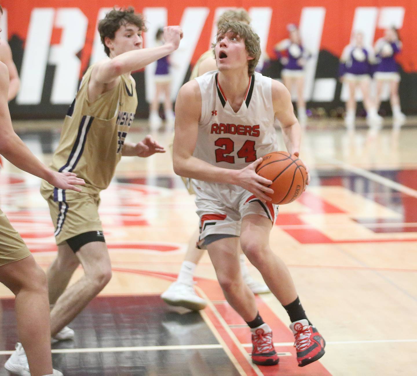 Earlville's Ryan Browder eyes the hoop as he is met in the lane by Serena's Hunter Staton on Friday, Feb. 9, 2024 at Earlville High School.