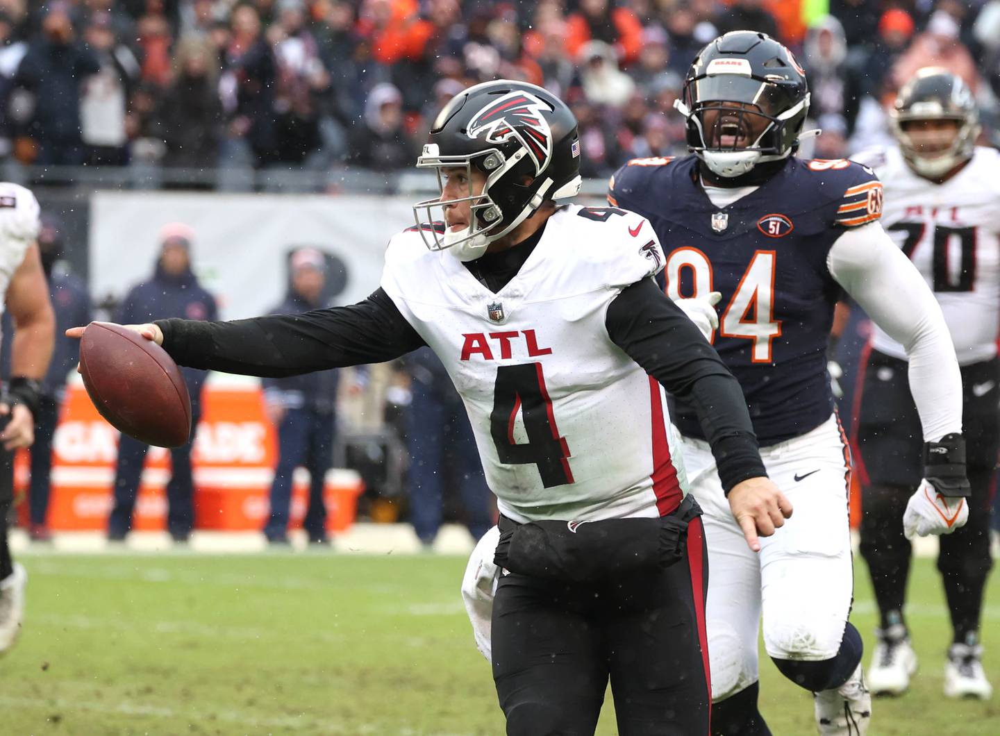 Atlanta Falcons quarterback Taylor Heinicke runs for a touchdown as Chicago Bears defensive end Rasheem Green pursues during their game Sunday, Dec. 31, 2023, at Soldier Field in Chicago.