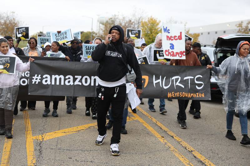 Protesters walk along Cashel Road during a staged walkout at Amazon’s  MDW2 facility. Amazon employees of MDW2 are teaming with Workers for Justice, a nonprofit organization supporting warehouse workers, to demand a safer work place and jobs that offer a living wage.