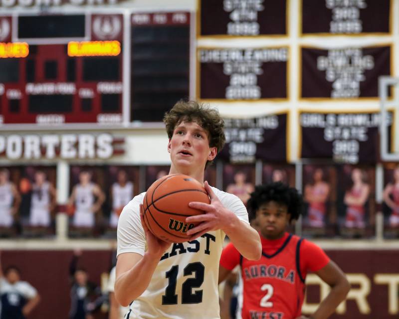 Oswego East's Ryan Johnson (12) shoots a free throw during Class 4A Lockport Regional final game between West Aurora at Oswego East.  Feb 24, 2023.