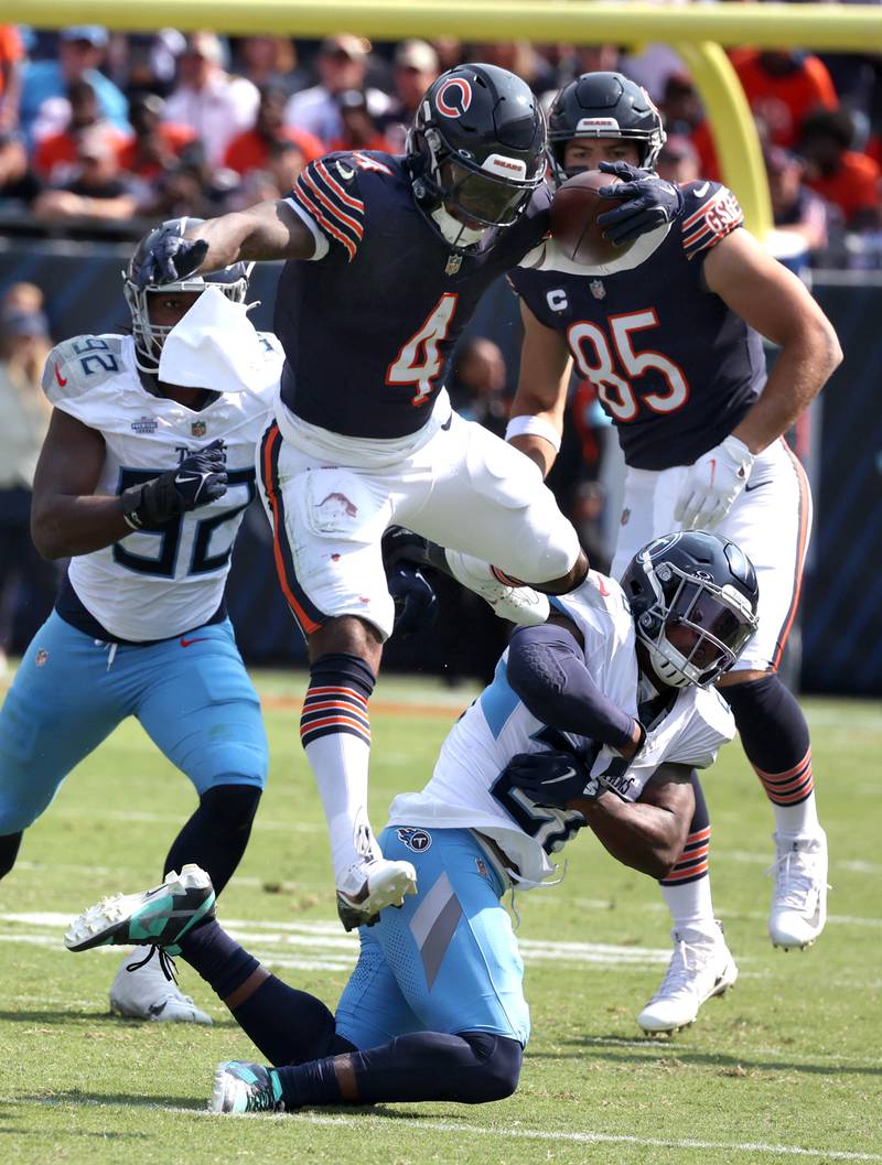 Chicago Bears running back D'Andre Swift hurdles Tennessee Titans safety Quandre Diggs during their game Sunday, Sept. 8, 2024, at Soldier Field in Chicago.