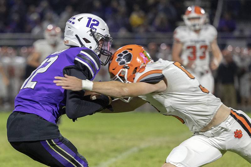 Dixon’s Gabe Rowley is hit by Byron’s Liam Connell Friday, Oct. 18, 2024, at A.C. Bowers Field in Dixon.