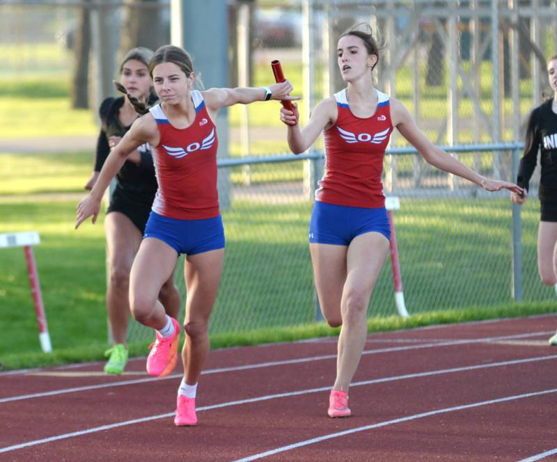 Oregon's Daleanah Koertner hands the baton to anchor Grace Tremble in the 4x200 relay at the 1A Oregon Sectional on Friday. May 10, 2024. The Hawks took second in the race behind Forreston-Polo to qualify for the state meet in Charleston.