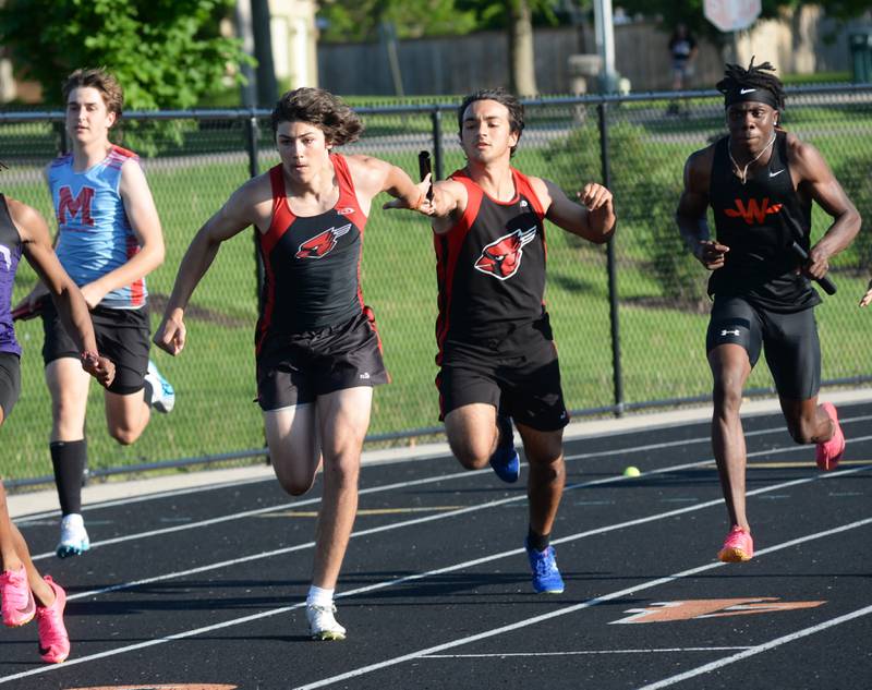 Forreston's De'Angelo Fernandez hands the baton to Jonathan Milnes in the 4x100 relay at the 1A Winnebago Sectional on Friday, May 17, 2024 in Winnebago. The Cardinals finished second in the event to qualify for the state finals at Eastern Illinois University in Charleston.