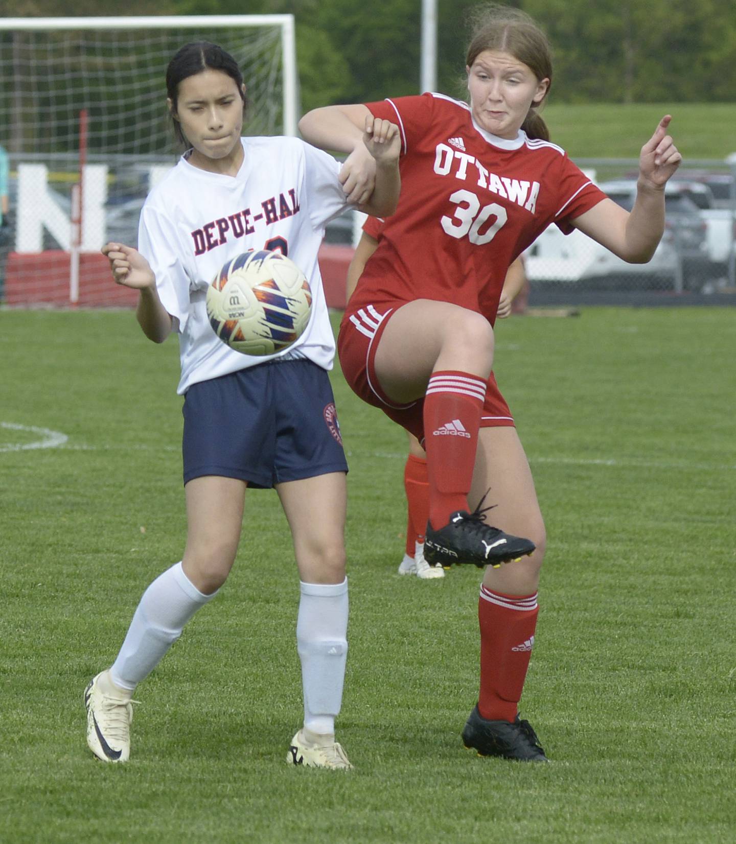 Ottawa’s Sophia Falaney and DePue/Hall's Jenny Reyes collide while fighting for control of the ball during match Thursday at Ottawa.