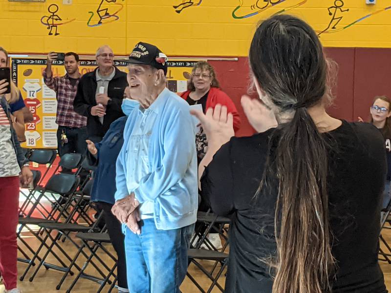 Those at Friday's Veterans Day assembly at Prairie Point Elementary School in Oswego sing Happy Birthday to World War II veteran Duane Stevenson , who will turn 100 on Saturday, which is Veterans Day.