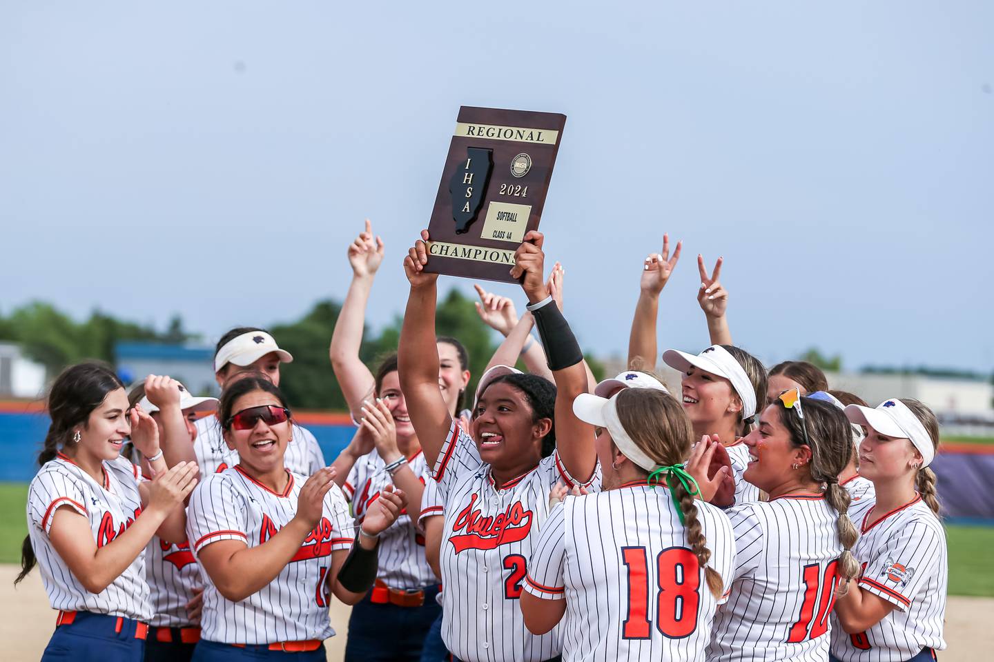 Oswego celebrates with the Class 4A Oswego Regional final plaque after defeating Yorkville.  May 24th, 2024