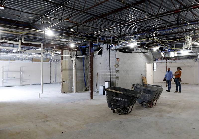 Construction workers walk inside the old Cary Village Hall, at 655 Village Hall Drive in Cary, on Tuesday, Feb. 7, 2023. Work has started on converting the space into the McHenry County Sheriff's Office's new law enforcement training facility. The facility will allow local agencies to train closer to home.