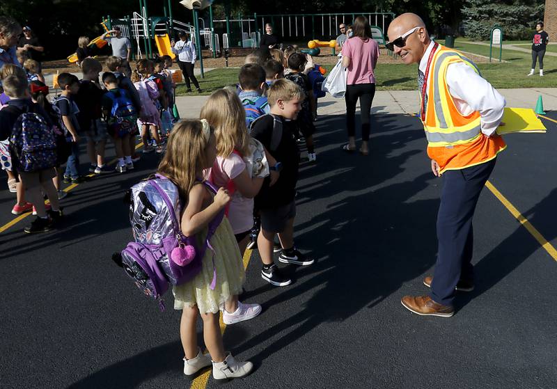 Coventry Elementary School Principal Matthew Grubbs talks with students as they line up for the first day of school on Wednesday, Aug. 21, 2024, at Coventry Elementary School in Crystal Lake.