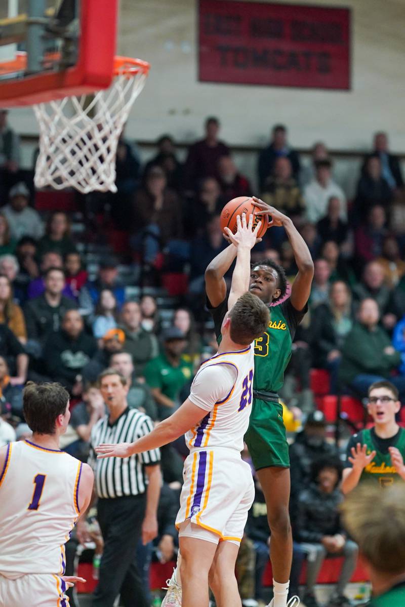 Waubonsie Valley's Tre Blissett (3) shoots the ball over Downers Grove North's Jack Stanton (21) during a Class 4A East Aurora sectional semifinal basketball game at East Aurora High School on Wednesday, Feb 28, 2024.