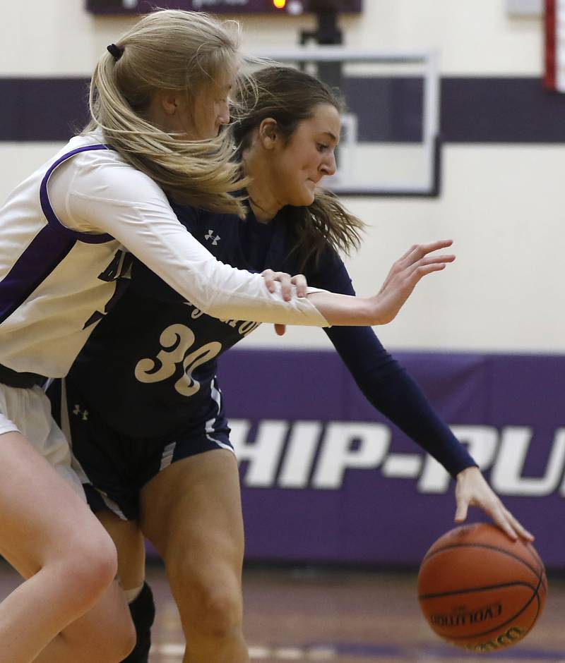 Cary-Grove's Sam Skerl tries to drive to the basket against Hampshire's Avery Cartee during a Fox Valley Conference girls basketball game Friday, Jan. 26, 2024, at Hampshire High School.