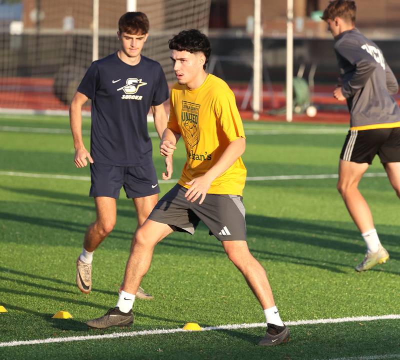 DeKalb County United players get warmed up during practice Thursday, June 6, 2024, at the Northern Illinois University Soccer and Track and Field Complex in DeKalb.