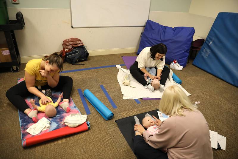 Patricia Ideran (center), a pediatric occupational therapist and certified in baby yoga and massage for Northwestern Medicine, teaches a baby yoga class with (from left) Kristen Calvallo of Hanover Park and her daughter, Kalylah, 5 months, and Alicia Hollander of Wheaton and her son, Lucas, 5 months, at Northwestern Medicine Central DuPage Hospital in Winfield.