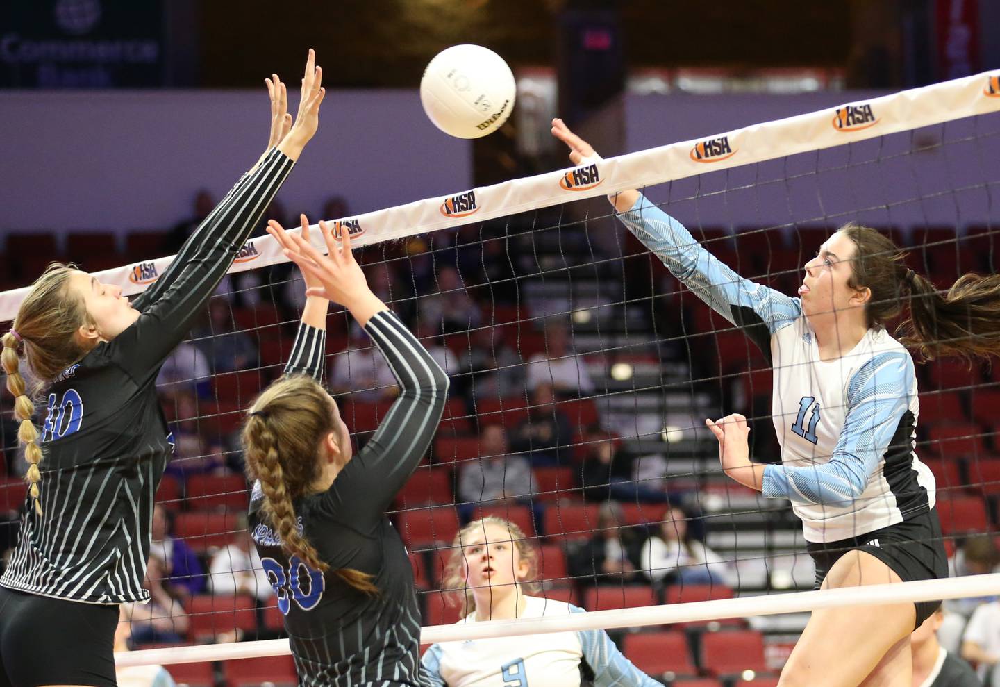 Joliet Catholic's Ava Neuschwander (11) spikes the ball past St. Francis's Anna Paquette (10) and teammate Emma Delaney (30) in the Class 3A semifinal game on Friday, Nov. 11, 2022 at Redbird Arena in Normal.