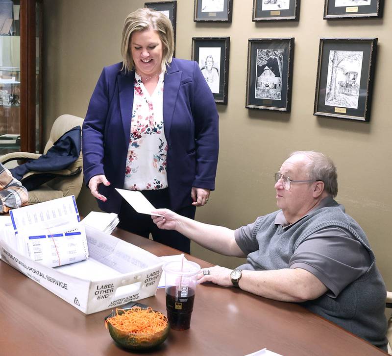 DeKalb County Clerk Tasha Sims visits with election judges Terry Heiland (left) and Steve Nemeth as they put vote-by-mail ballots in envelopes Wednesday, Feb. 22, 2023, in the DeKalb County Administration Building in Sycamore.