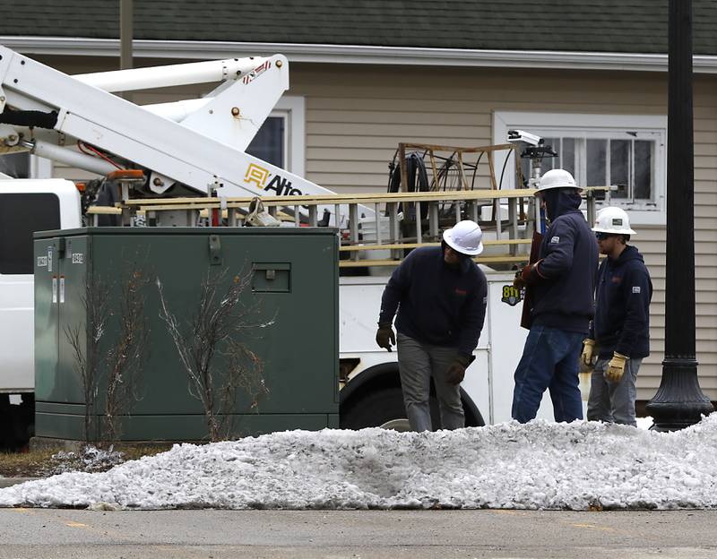 ComEd employee check an electrical box as they work on restoring power to parts of downtown Crystal Lake on Thursday, Feb. 23, 2023, as county residents recover from a winter storm that knocked down trees and created power outages throughout McHenry County.