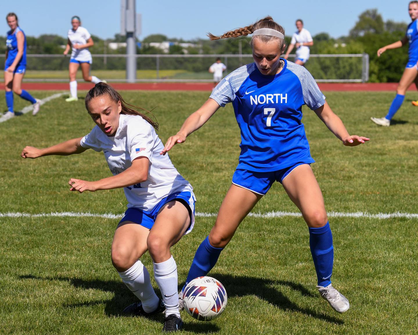 St. Charles North's Laney Stark (19) and Wheaton North's Caoah Strong (7) battle for the ball during the sectional title game held at South Elgin High School on Saturday May 25, 2024.