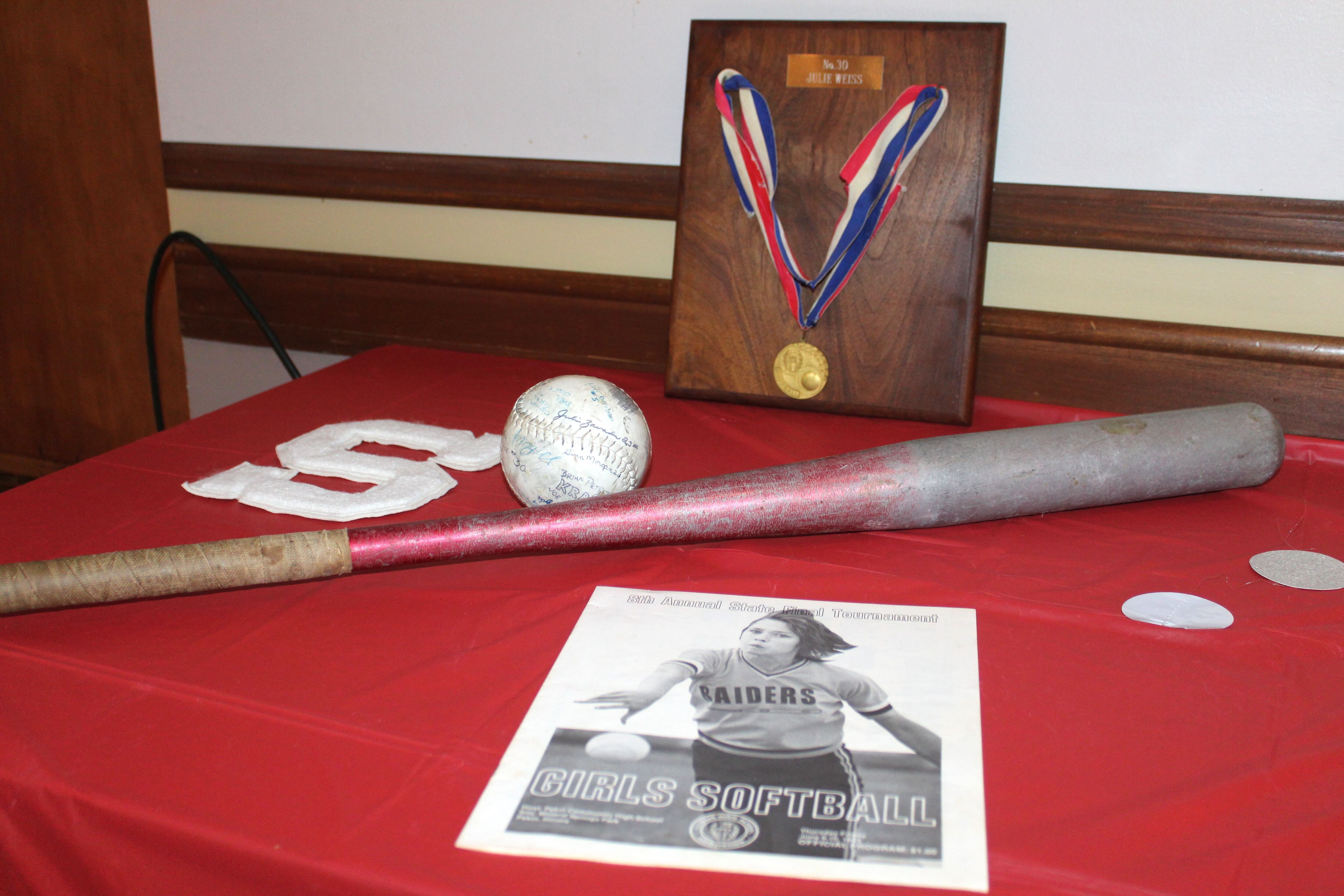 Julie (Weiss) Gabehart's state championship medal, a softball signed by the 1983 Streator softball team, a bat and the IHSA state tournament program were on display at the Night of Champions event Saturday, June 10, 2023, at the Streator PNA Hall marking the 40th anniversary of the team’s state championship.