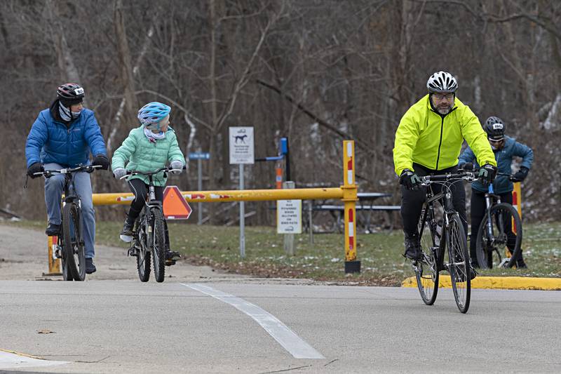 Shane Miller (right), crosses Washington Ave. near the end of the day’s ride Monday, Jan. 1, 2024.