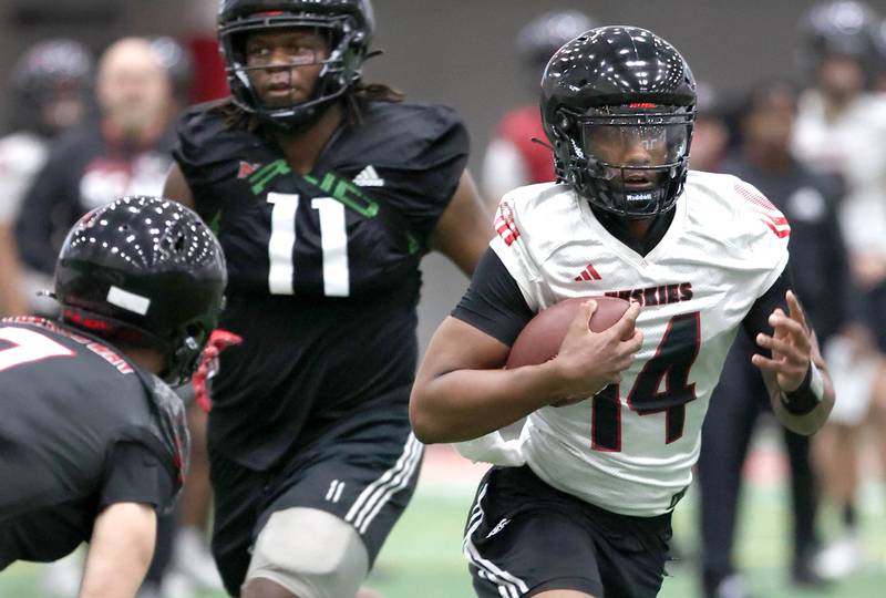Northern Illinois University quarterback Jalen Macon carries the ball Tuesday, March 26, 2024, during spring practice in the Chessick Practice Center at NIU.