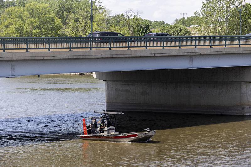 Dixon firefighters work on the Rock River Thursday, May 23, 2024 to place safety buoys along the channel.