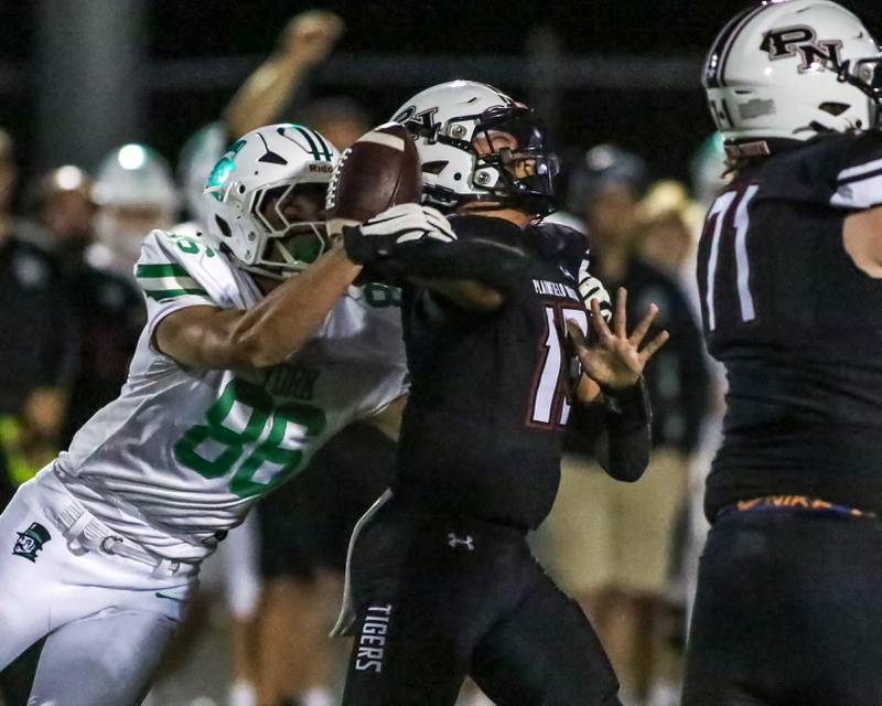 York's Owen Roberts (86) knocks the ball out of the hand of  Plainfield North's Justus Byrd (13) during a football game between York at Plainfield North on Friday, Sept 6th, 2024 in Plainfield. Gary E Duncan Sr for Shaw Local News Network.