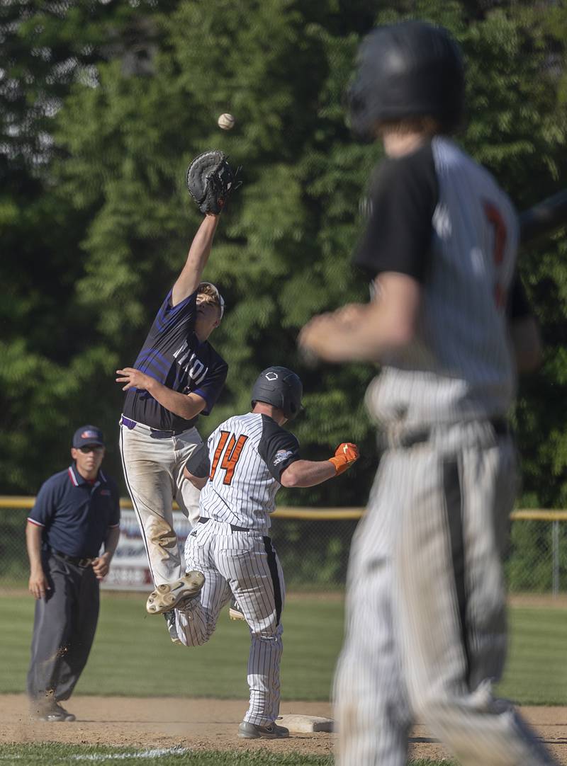 Dixon’s Brady Lawrence leaps for a high throw against Freeport Thursday, May 23, 2024 during the Class 3A regional semifinal in Dixon.