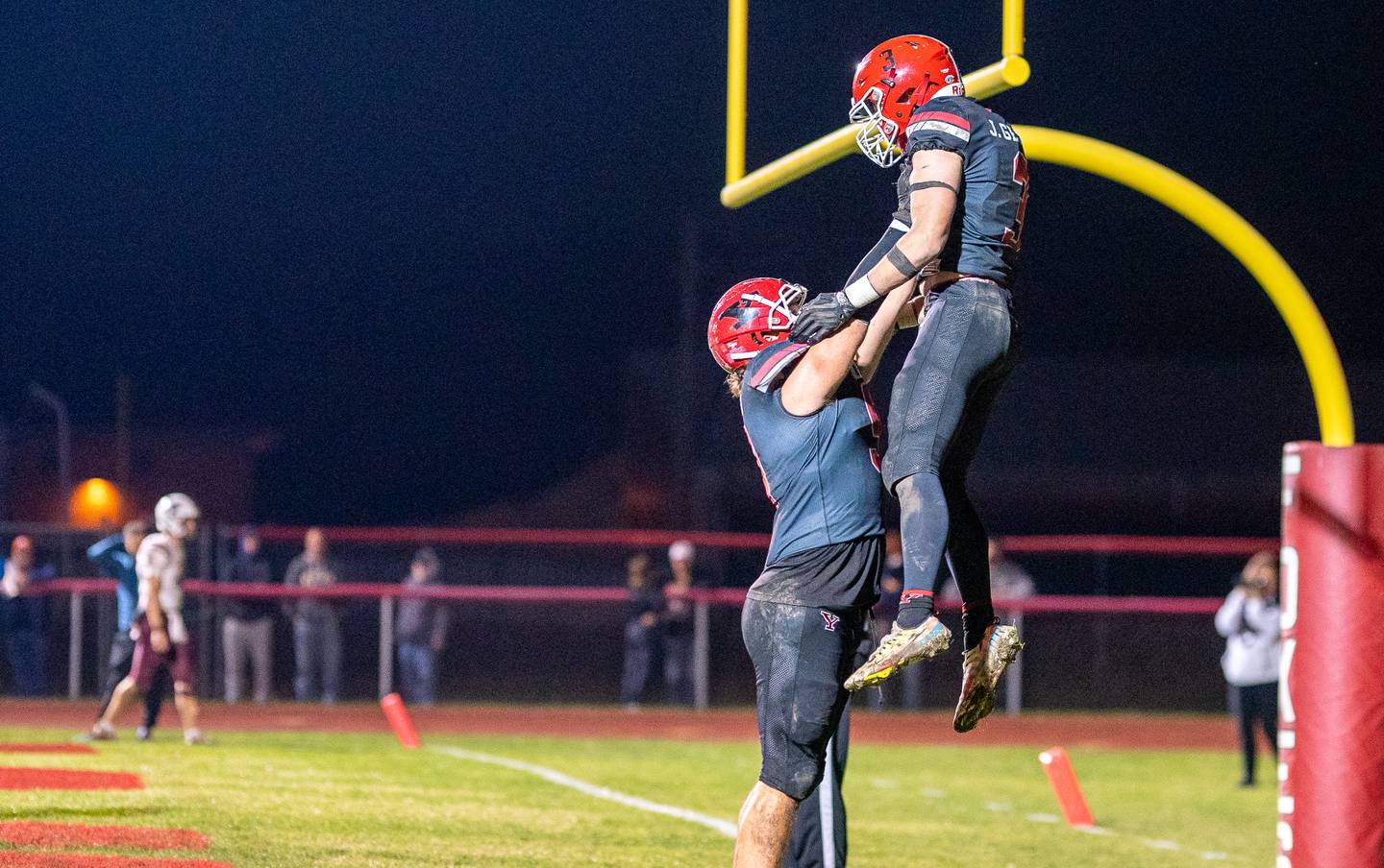 Yorkville's Andrew Laurich (left) lifts Josh Gettemy (3) in the air after a touch town against Moline during a 7A second round playoff game at Yorkville High School on Friday, Nov 4, 2022.