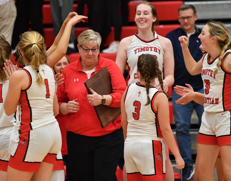 Timothy Christian girls basketball coach Jill Groenewold reacts after she was given the championship plaque after the Class 2A Timothy Christian Regional championship game against IC Catholic Prep on Feb. 17, 2023 at Timothy Christian High School in Elmhurst.