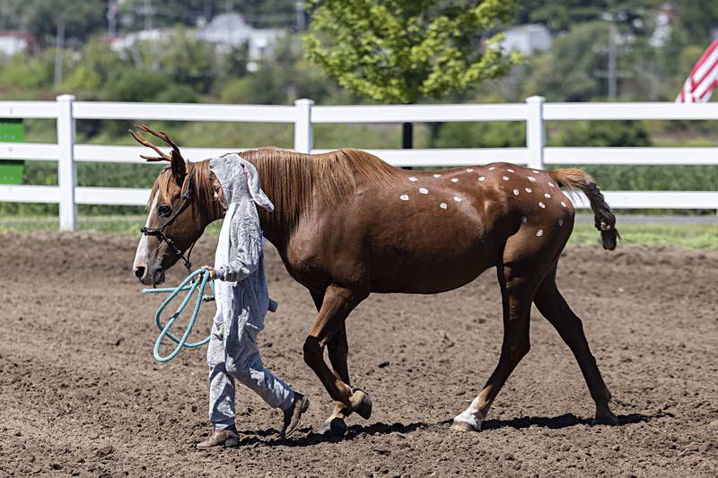 Easrtyn Zumdahl, 10, of Baileyville walks with her horse Tia as Bambi and Thumper in the open costume contest Saturday, August 12, 2023 at the Carroll County Fair.