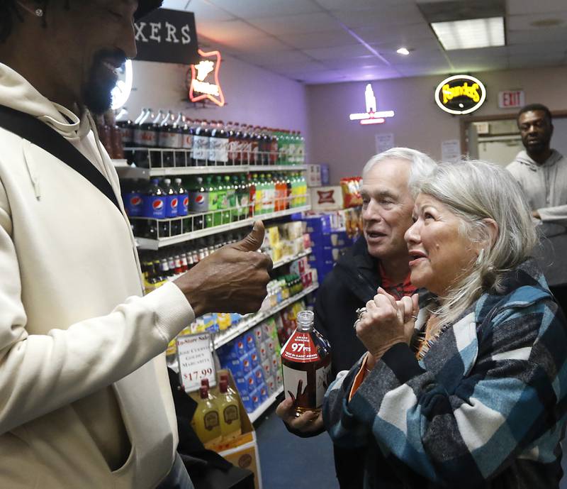 Retired Chicago Bulls star Scottie Pippen gives a ‘thumbs up” to Dave and Lydia Keehn after he signed a bottle of his Digits bourbon Thursday, Feb. 9, 2023, at The International House of Wine and Cheese, at 11302 Route 12, in Richmond.