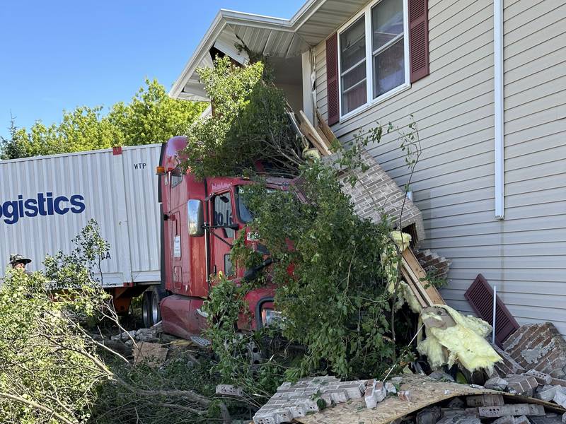 The semi came to a stop against the building in the 1800 block of East Anne Lane Wednesday morning, taking the treeline from Interstate 80 along with it.