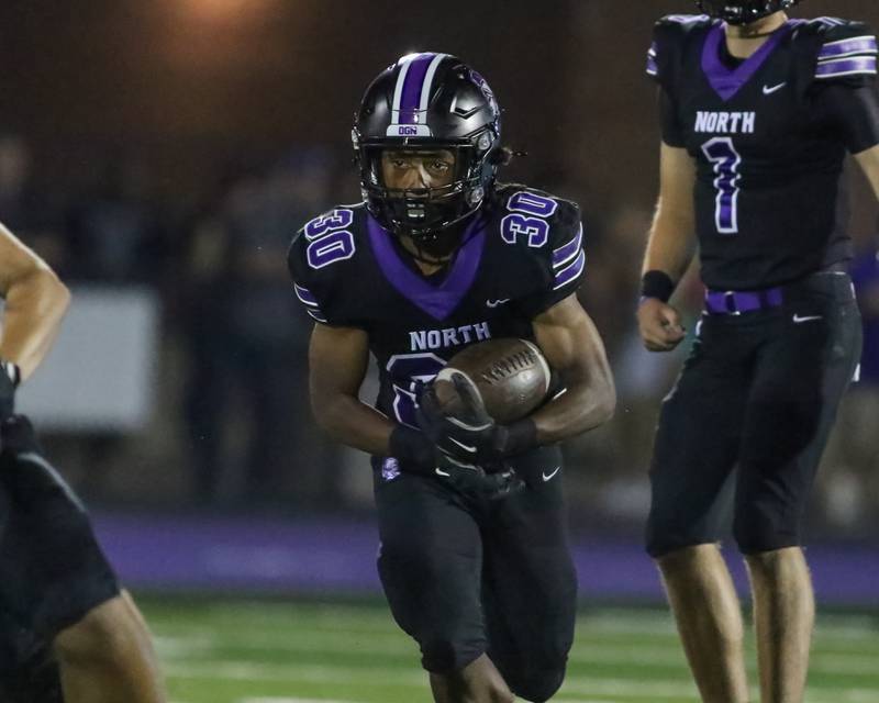 Downers Grove North's James Lumpkin (30) runs with the ball during a football game between Glenbard West at Downers Grove North on Friday, Sept 13th, 2024  in Downers Grove.