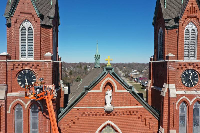 A worker tuckpoints spires on St. Hyacinth's Catholic Church on Tuesday, March 14, 2023 in La Salle. Last May, the church launched a $1.8 million capital campaign for a new roof, facade improvements and interior work.
