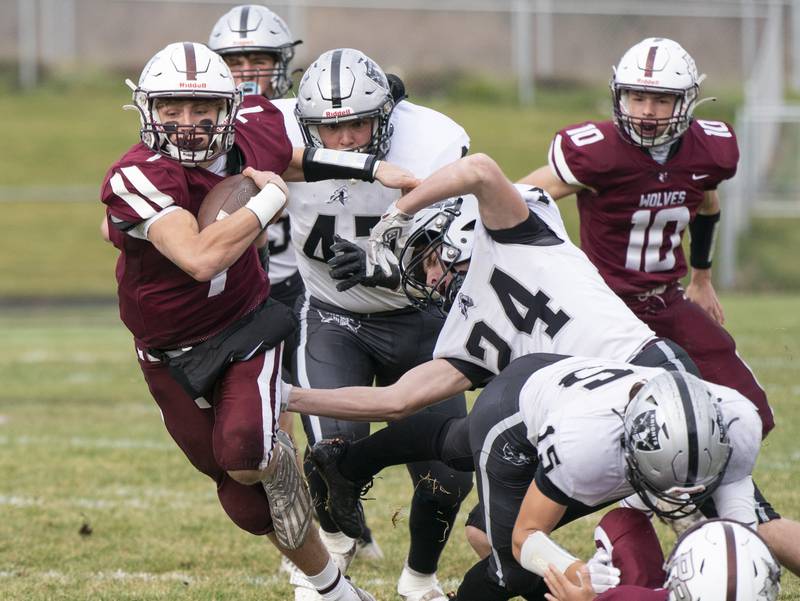 Prairie Ridge quarterback Tyler Vasey breaks a tackle from Kaneland's Anthony Urban to score a touchdown in the first quarter during the 6A second-round football playoff game on Saturday, November 5, 2022 at Prairie Ridge High School in Crystal Lake. Prairie Ridge won 57-22.