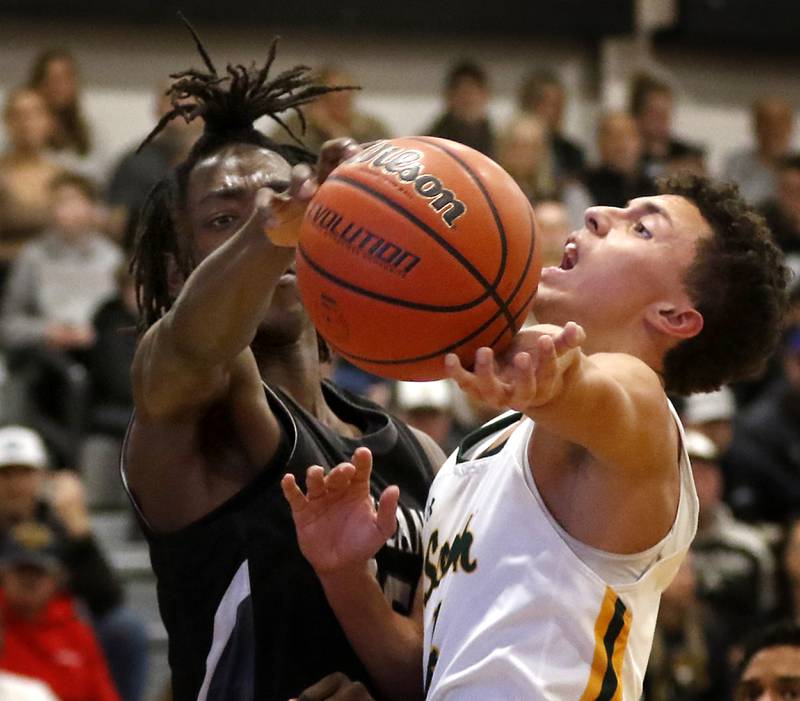 Crystal Lake South's AJ Demirov tries to drive to the basket against Kaneland's Evan Ross during the IHSA Class 3A Kaneland Boys Basketball Sectional championship game on Friday, March 1, 2024, at Kaneland High School in Maple Park.