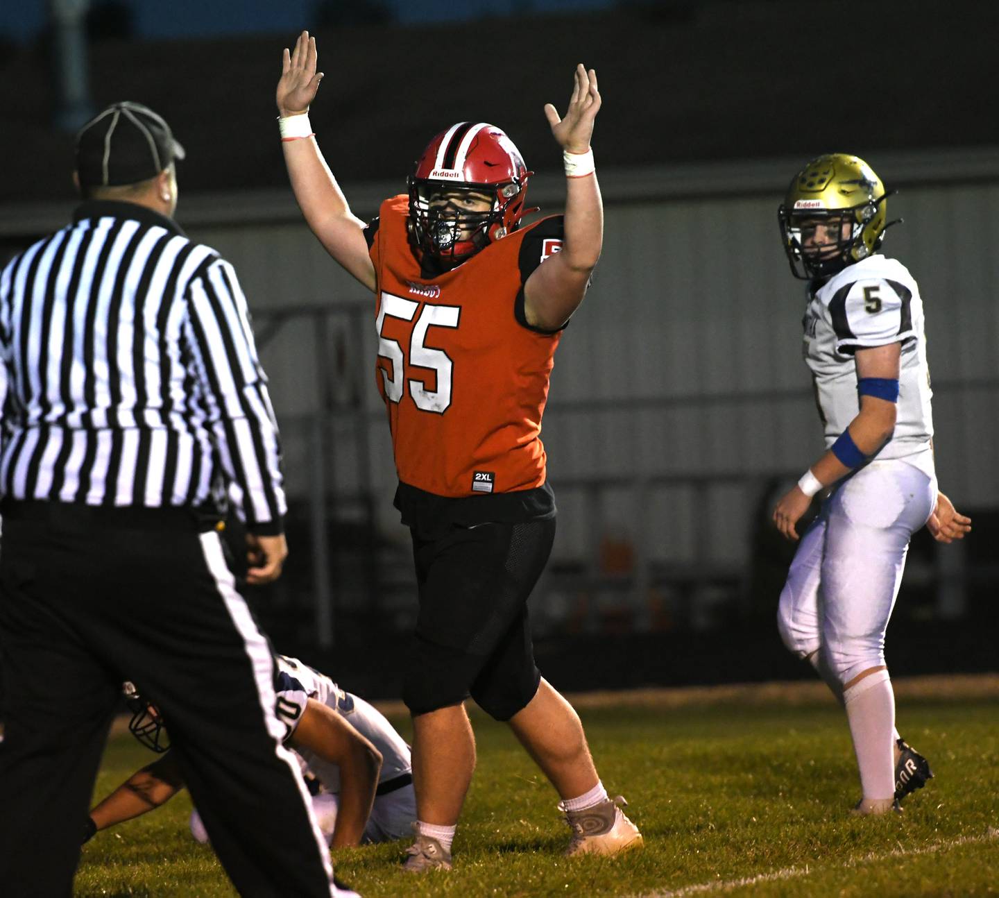 Amboy's Landon Montavon signals a TD as Hiawatha's Thomas Butler watches on Friday. Sept 30.