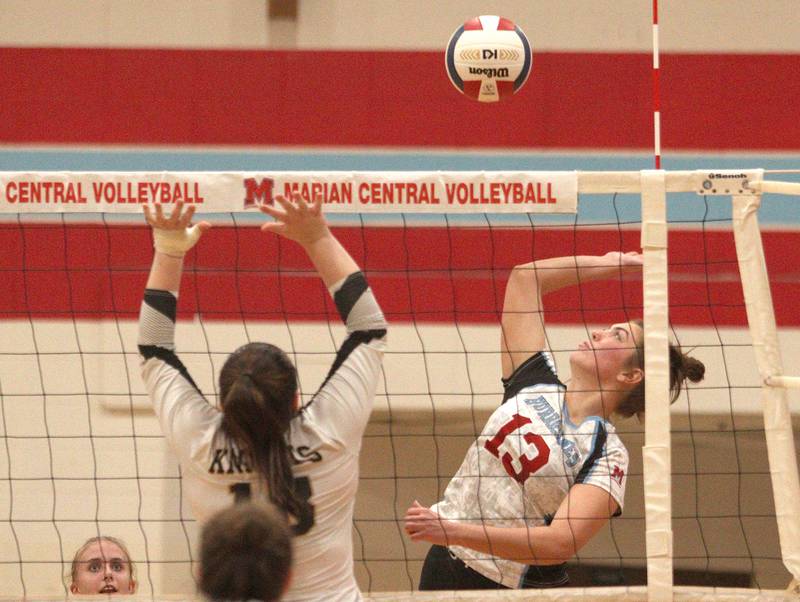 Marian Central’s Lucy Iden sends the ball over the net against Grayslake North in girls volleyball in Woodstock Monday.