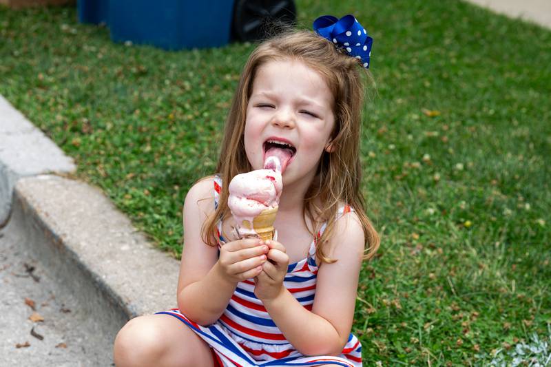 A little girl from the Kresyman family enjoys an ice cream cone at the Hinsdale 4th of July Family Celebration.  July 4th, 2024.