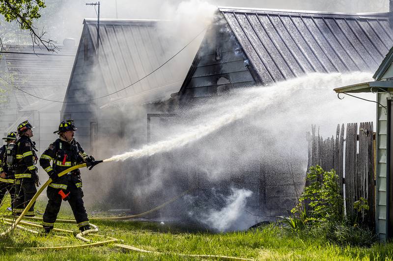 Firefighters work at the scene of a house fire at 204 East 11th Street in Rock Falls Wednesday, May 1, 2024. Neighbors heard an explosion prior to the house fire on the State Fire Marshal is investigating.